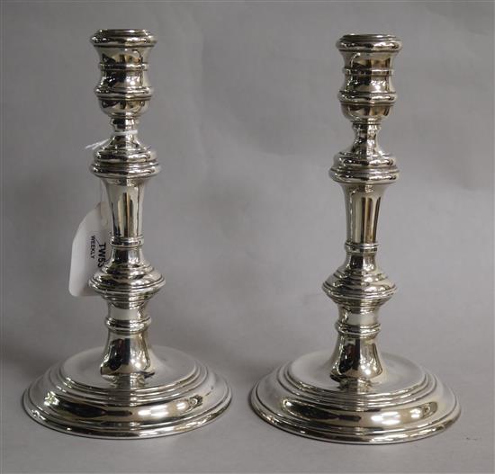 A pair of silver candlesticks with knopped stems, weighted,